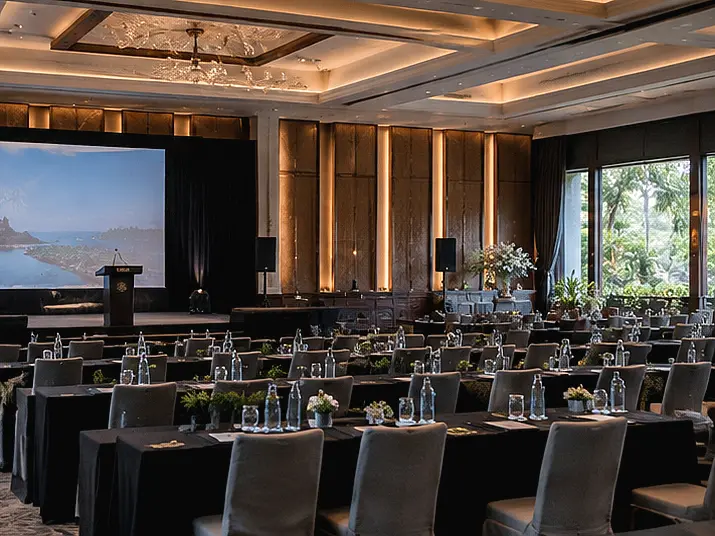Conference room setup with rows of seating and a stage, illustrating key factors to consider when choosing a Corporate Event Planner in Bali